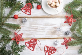 Christmas or New Year frame composition. Decorations, red stars, bells, cones, fir and spruce