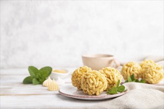 Traditional Tatar candy chak-chak made of dough and honey with cup of coffee on a white wooden