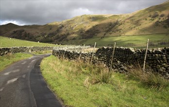 Narrow country road in Martindale valley, Ullswater, Lake District national park, Cumbria, England,