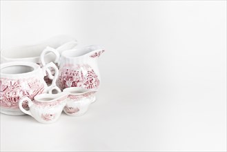 White porcelain crockery with red details, white background, copy room