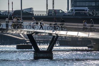 Cyclists on the Lille Langebro cycle and pedestrian bridge over the harbour, Copenhagen is