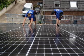 Installation of solar modules on the roof of a barn on a farm, over 240 photovoltaic modules are