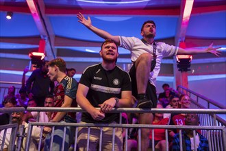 Fans of the British team gesticulate loudly at the Adidas fan zone at the Bundestag during the