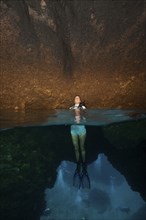 Half and half shot half-and-half shot spiit shot of diver female diver emerges into underground