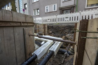 Construction site of a district heating house connection, pipes, insulated, are laid from a central