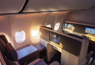 Modern airplane interiors, luxury first class and business class seats with entertainment area