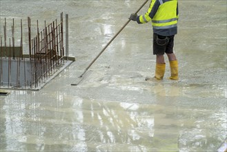 Construction site, concreting, the floor slab of a building is concreted, the fresh concrete is