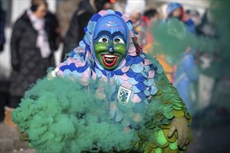 Hofener Scillamännle with smoke bomb at the big carnival parade, Hofen, Stuttgart,