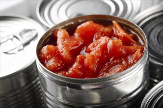 Canned sliced tomatoes in just opened tin can. Non-perishable food