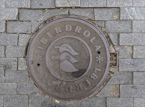 Madrid manhole cover on a busy street in Madrid, Spain, Europe