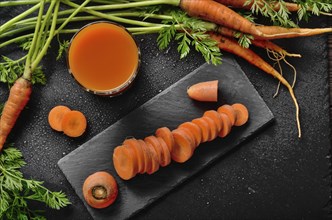 Top view at fresh organic vegetarian carrot juice on wooden kitchen table