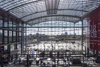 Berlin Central Station, glass front with Deutsche Bahn AG logo. View of people on the forecourt and