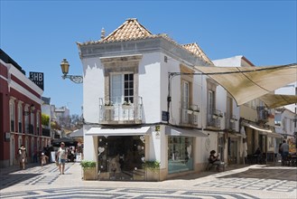 White historic buildings with small shops on a cobbled shopping street, pedestrianised area, Old