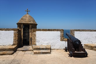 Historic fortress with cannon and sea view under a blue sky, Baluarte y Murallas de San Carlos,