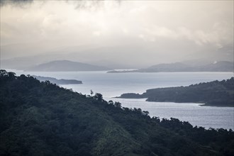 View to the sea over wooded hills, at sunset, cloud forest, Monte Verde, Puntarenas province, Costa