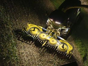 Tractor at night harvesting field with illuminated harvester, corn harvest, Dachtel, Black Forest,