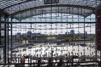 Berlin Central Station, glass front with Deutsche Bahn AG logo. View of people on the forecourt and