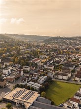 Urban aerial view with residential buildings, hills and river in warm autumn colours, Nagold, Black