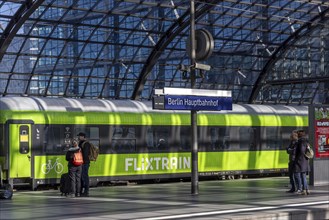 Central station, pillarless glass roof construction above the platforms, station sign and train of