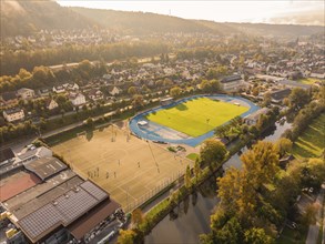 Aerial view of a sports field in a town, surrounded by autumn-coloured residential area, Nagold,