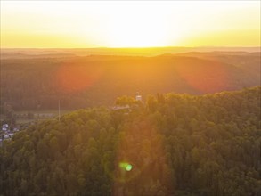 View of wooded hills at sunset, warm light over the mountains, Nagold, Black Forest, Germany,