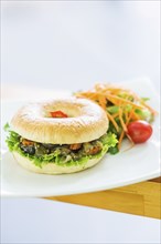 Roast vegetable vegetarian bagel with salad