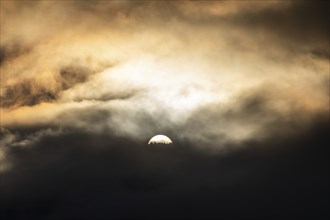 Sun above a mountain range breaking through morning clouds and fog, Leoben, Styria, Austria, Europe