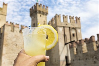 Hand with fresh cold lemonade. Concept for enjoy, relaxation, travel, summer