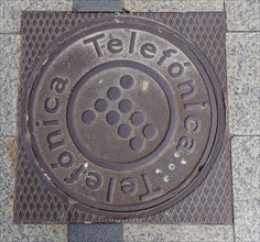 Madrid manhole cover on a busy street in Madrid, Spain, Europe