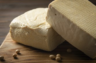 Soybean tofu vegetable bean curd on cutting board on kitchen table