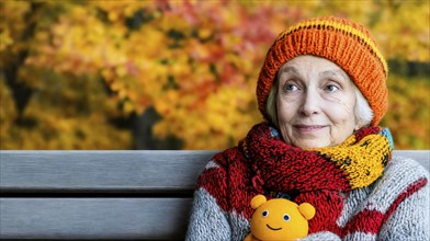 Senior citizen with orange knitted hat and cuddly toy sitting on a bench in autumn, generated with