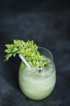 Healthy green vegetables juice glass with kale and celery