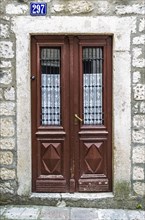 Brown wooden door in old house in Kotor, Montenegro, Europe