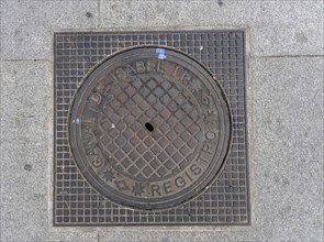 Madrid manhole cover on a busy street in Madrid, Spain, Europe