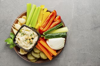 Flat lay view at vegetable Hummus dip dish topped with chickpeas and olive oil