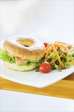 Smoked salmon and cream cheese bagel with salad