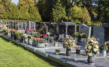 Anderlecht, Brussels, Belgium, 10 11 2018: Decorated grave yards on a cemetery against blue sky,