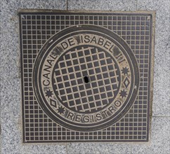 Madrid manhole cover on a busy street in Madrid, Spain, Europe