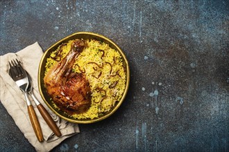 Delicious Indian dish Biryani chicken with basmati rice in metal brass old bowl on table rustic