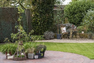 Garden with plant arrangement and seating area on a gravel path, Weseke, Münsterland, Germany,