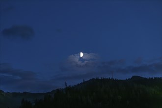 Moon over a range of hills, Mugel mountain, Leoben, Styria, Austria, Europe