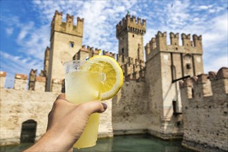 Hand with fresh cold lemonade. Concept for enjoy, relaxation, travel, summer