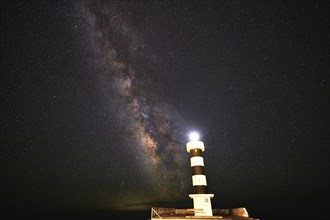 Lighthouse at night under the impressive Milky Way and starry sky, Colonia St. Jordi, Majorca,