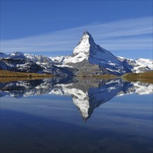 Snow capped Matterhorn mirroring in lake Stellisee