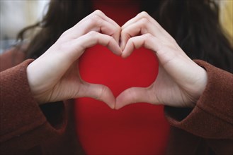 A close-up of a woman making a gesture of love. Valentines day