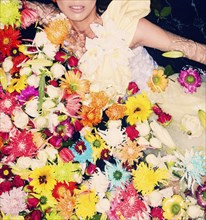 Fashion model posing with flowers in pool