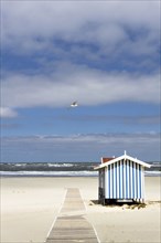 Lonely sandy beach with lifeguard tower, on the German North Sea coast