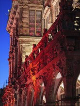 Detailed facade of a historic building with red lighting at dusk, Bremen, Germany, Europe