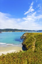 Beautiful rocky coastline and steps leading to sand beach below cliffs near Mendocino Bay on sunny