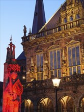 Illuminated historical building and statue red illumination at dusk, Bremen, Germany, Europe